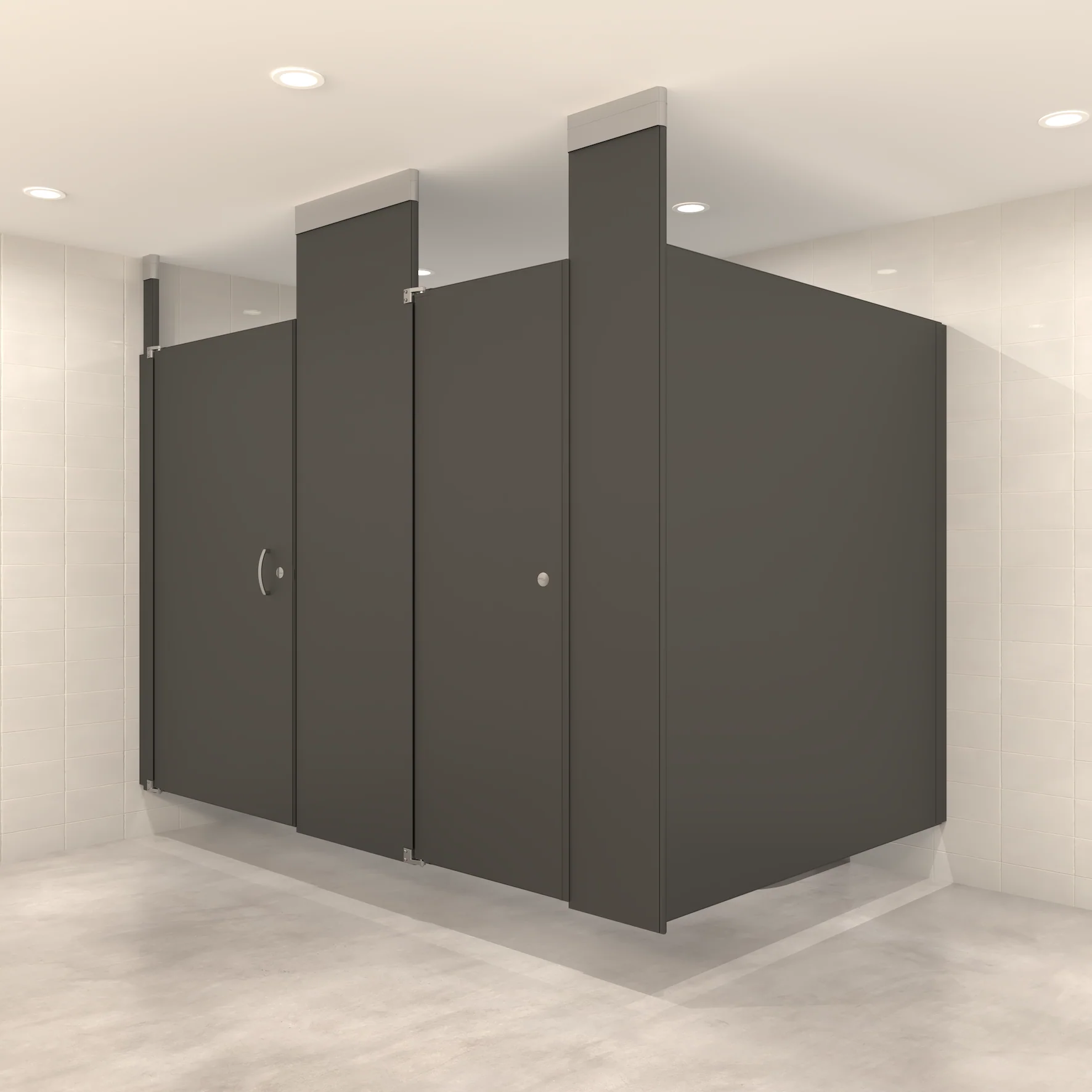Ceiling-hung toilet partitions in a commercial restroom showing two suspended bathroom stalls in charcoal gray with no floor contact