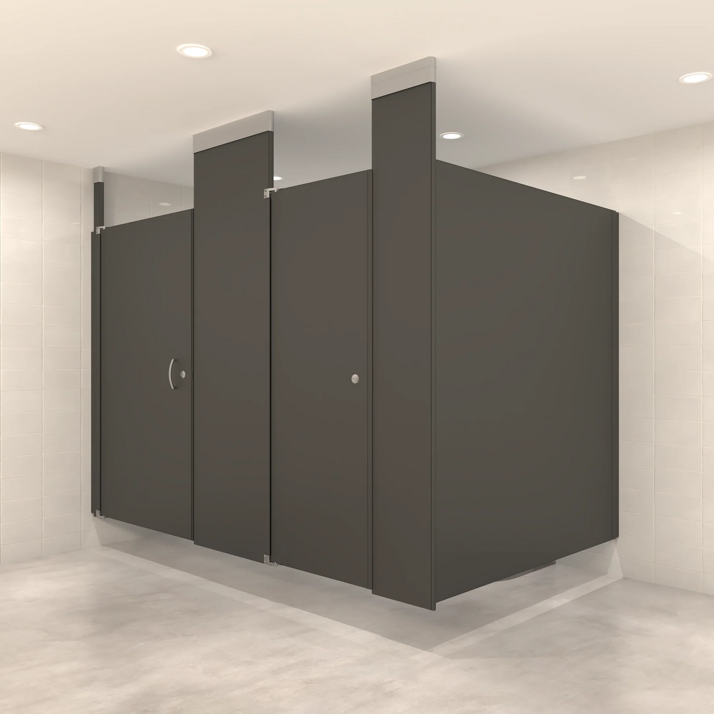 Ceiling-hung toilet partitions in a commercial restroom showing two suspended bathroom stalls in charcoal gray with no floor contact